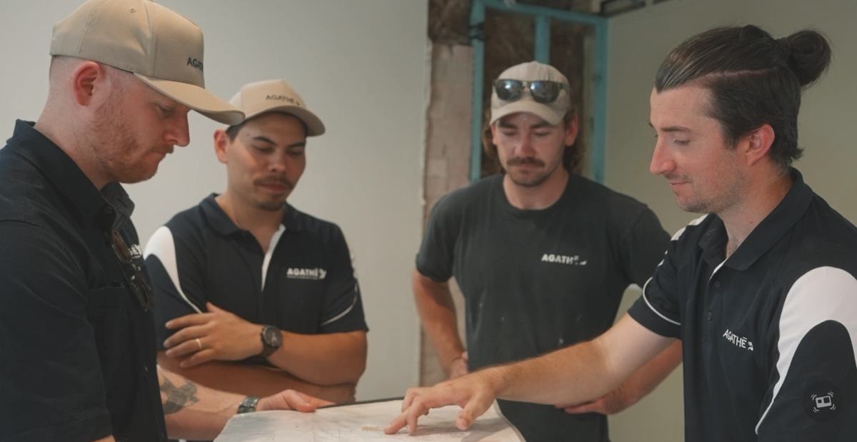 AGATHĒ team reviewing plans together during pre-construction planning