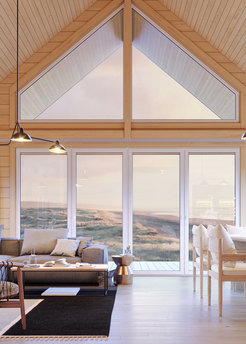 Scandinavian home interior with vaulted timber ceiling and ocean view
