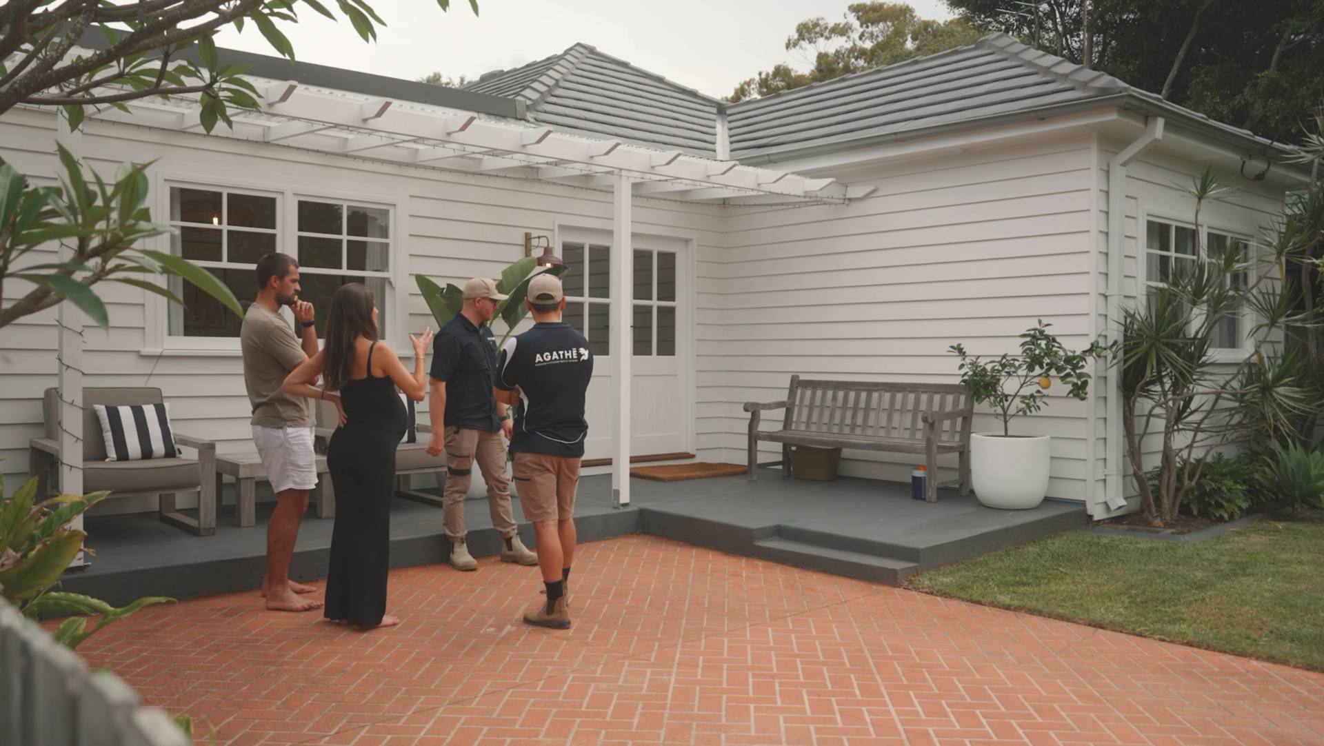 The AGATHĒ Builders team with clients at a completed home