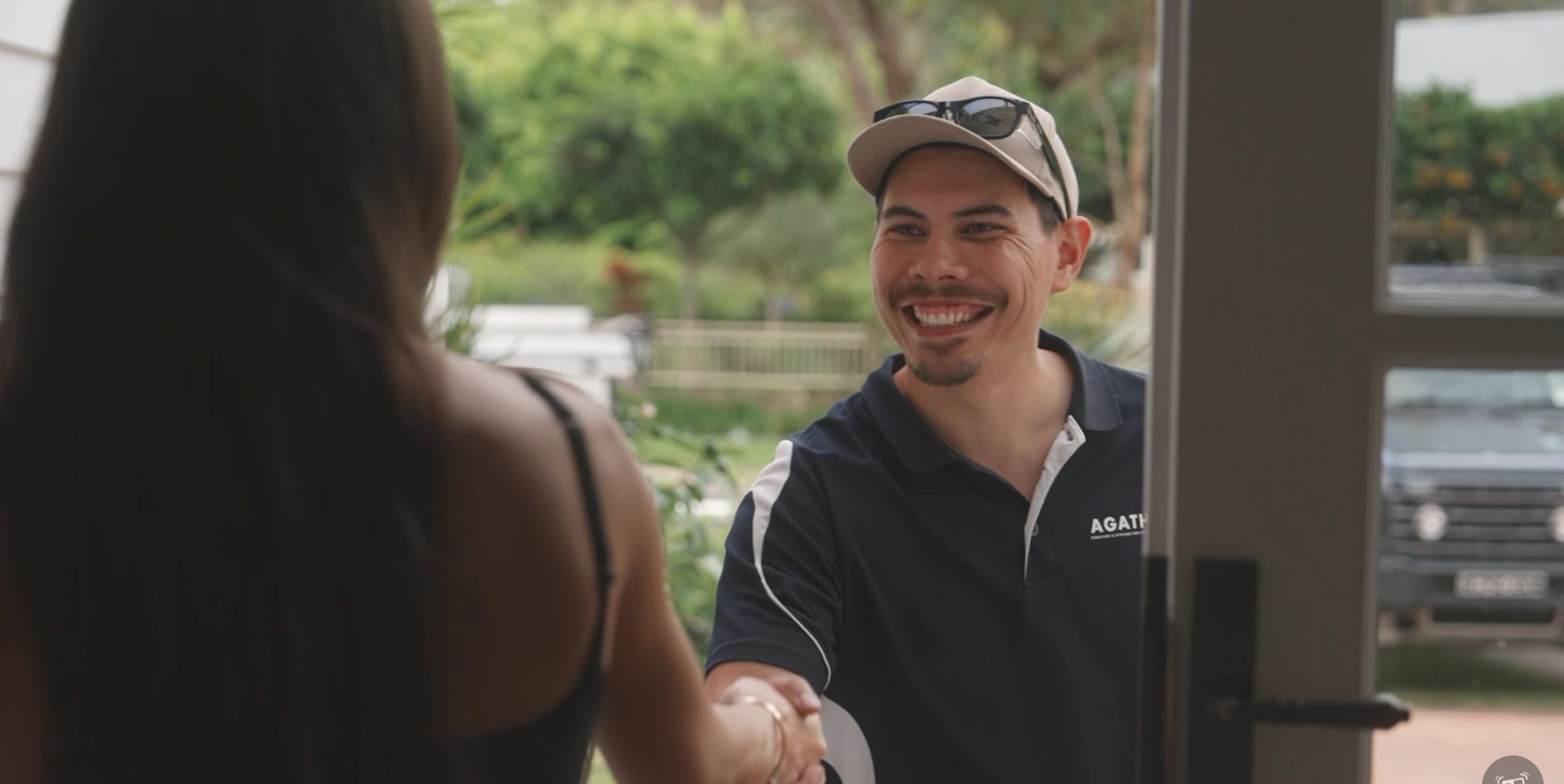 AGATHĒ team member greeting a client with a handshake