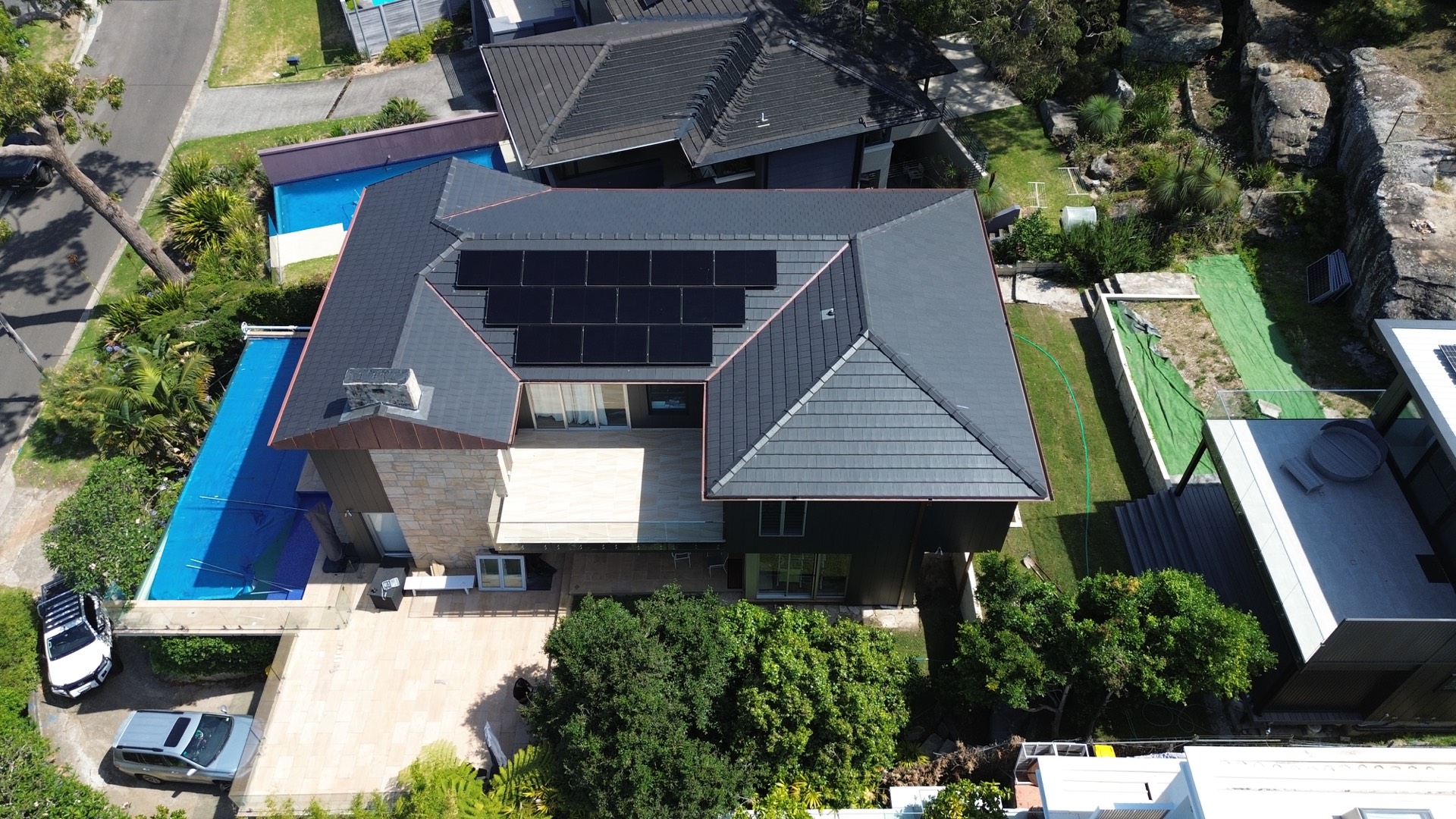 Aerial view of the completed Balgowlah Heights extension showing the tiled roof, solar panels, pool and garden