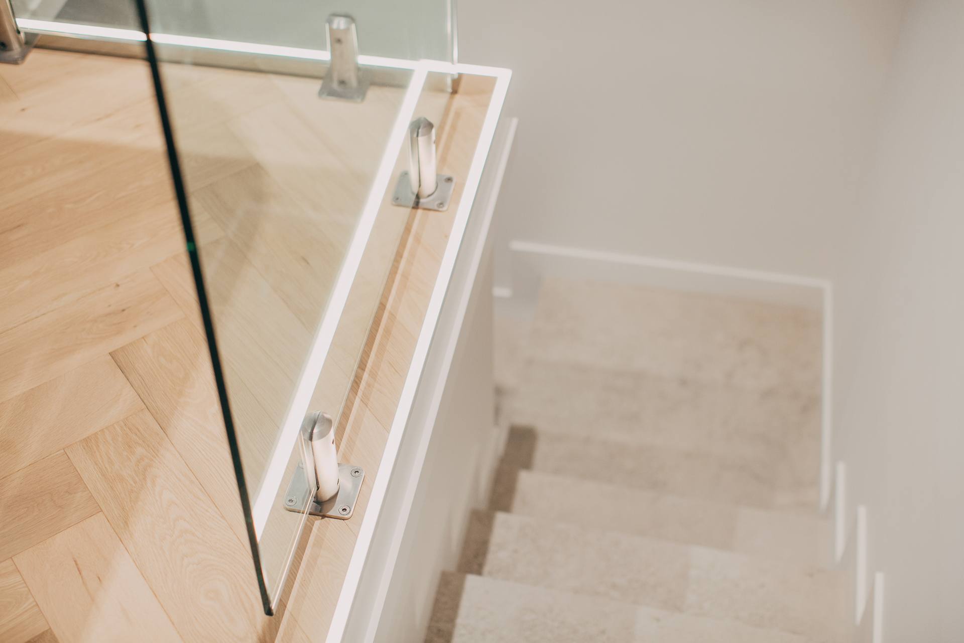 Frameless glass balustrade and herringbone parquetry flooring at the Castle Hill home