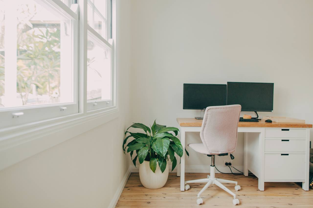 Home office with a built-in desk and window in the North Narrabeen home