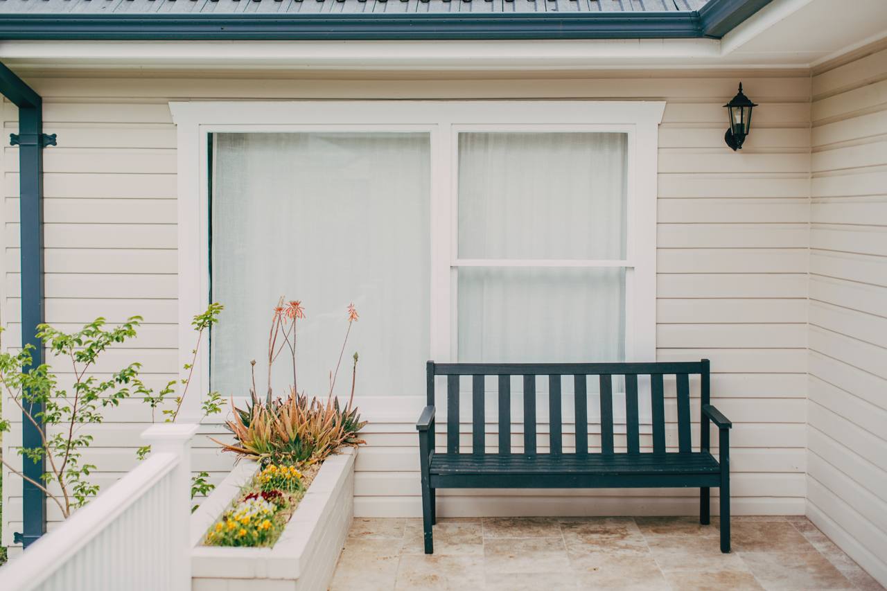 Front porch with a bench seat and planter at the Pymble home